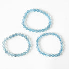 Three light blue Aqiuamarine beaded bracelets on a white background