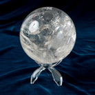 Clear crystal ball on a dark blue fabric background