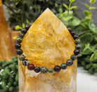 Dragon Bloodstone 6mm Smooth Bead Stretch Bracelet on stone display