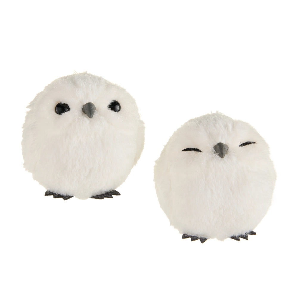 Two white plush owls with black eyes and beaks on a white background