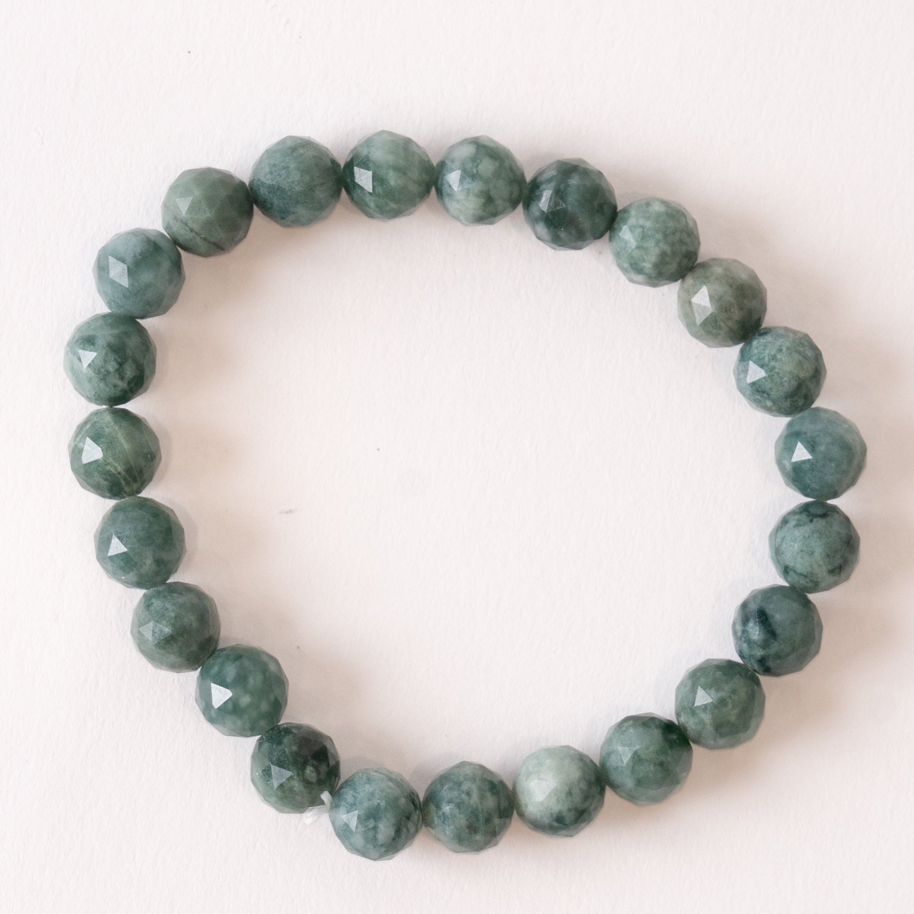 Green jade beaded bracelet on a white background