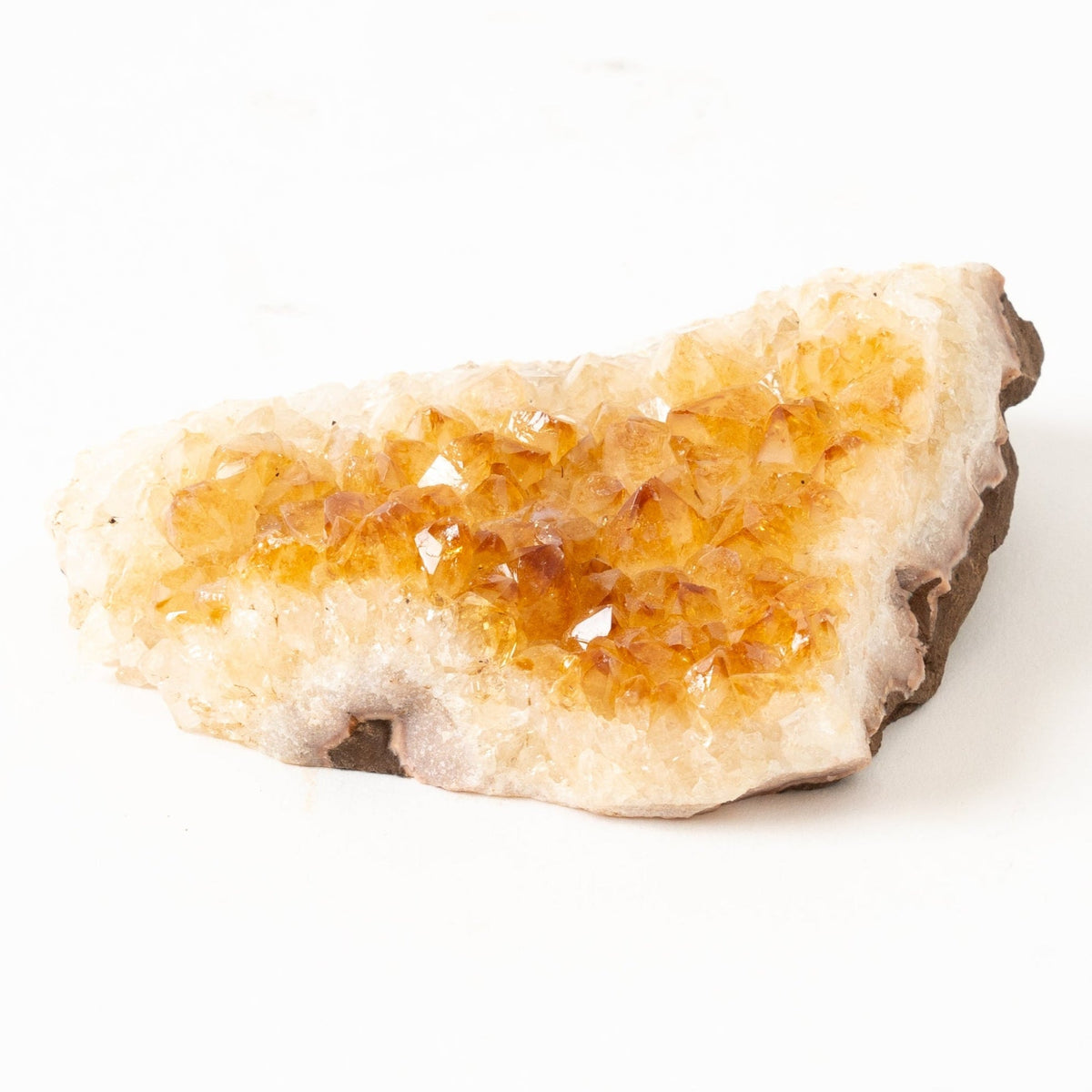 Citrine Crystal rock with a yellowish tint on a white background