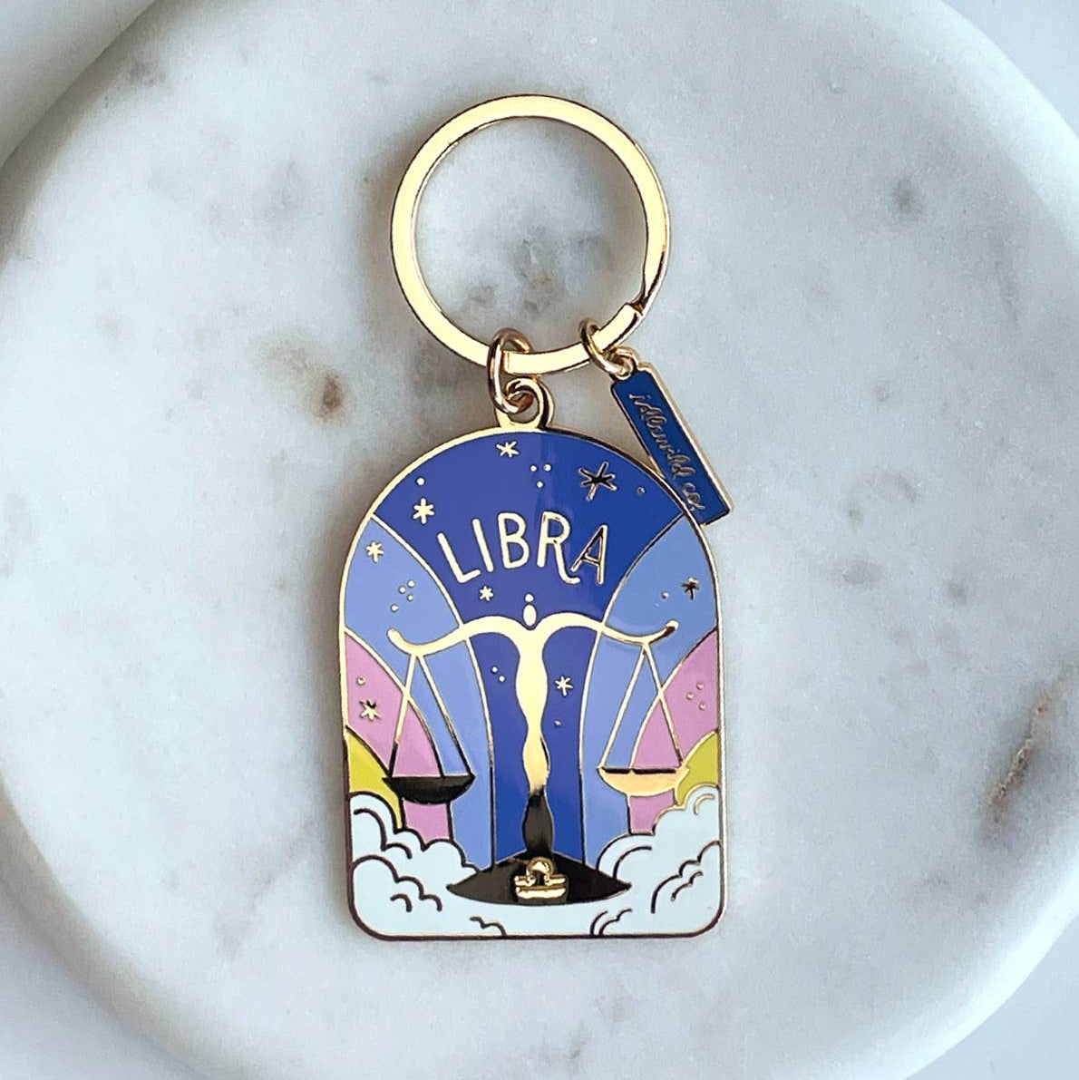 Keychain with Libra zodiac design on a marble surface