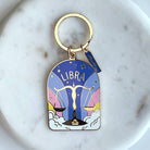 Keychain with Libra zodiac design on a marble surface