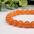 Calcite Orange 6mm Smooth Bead Stretch Bracelet closer view