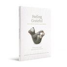 Book titled 'Feeling Grateful' with a sloth illustration on a white background