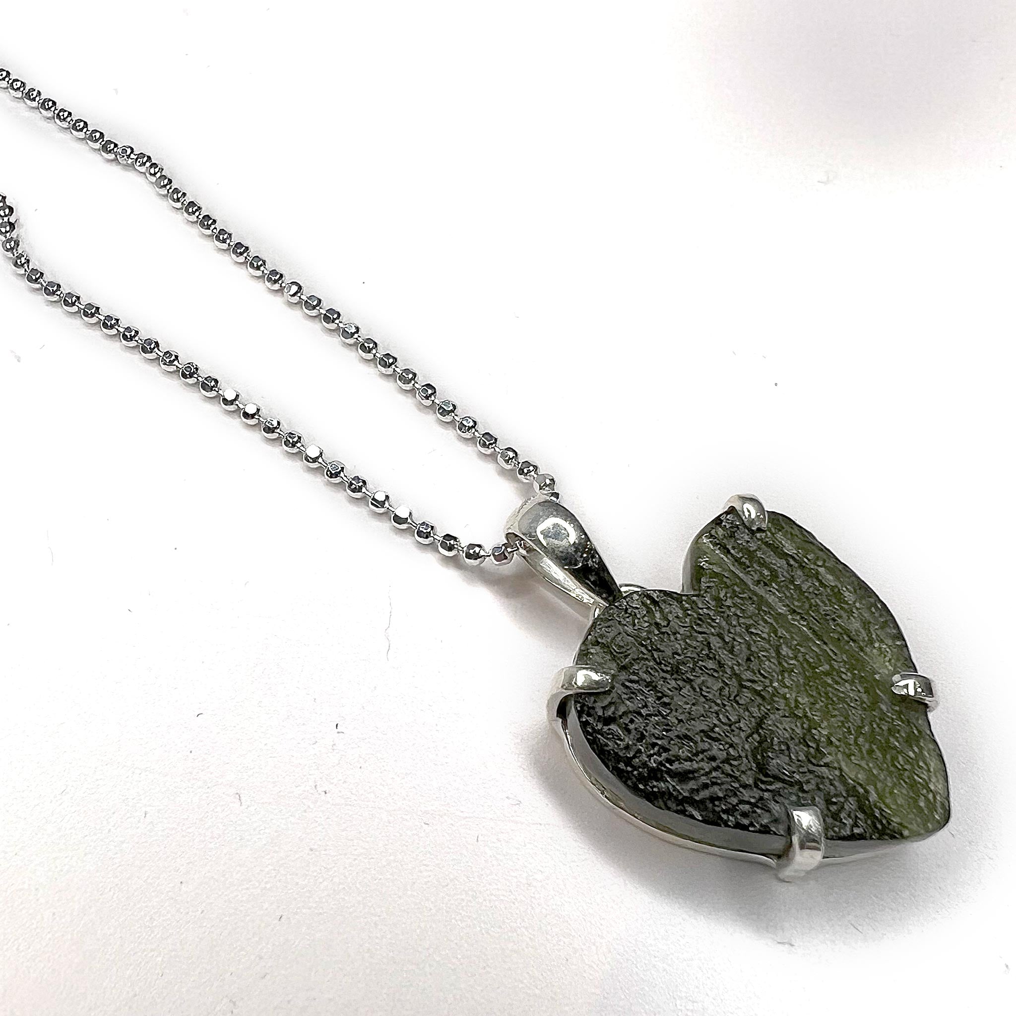 Moldavite Heart Pendant Necklace with 20" Sterling Silver chain at angle