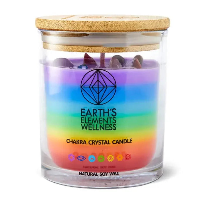 Chakra crystal candle with rainbow design and wooden lid on a white background
