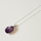 Purple Amethyst gemstone necklace on a white background