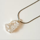 Necklace with a large, clear Herkimer Diamond crystal pendant on a light background