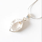Herkimer Diamond Crystal pendant necklace on a white background