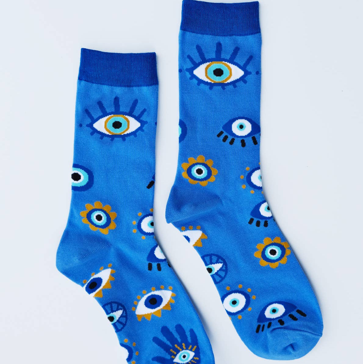 Blue socks with eye pattern on a light gray background