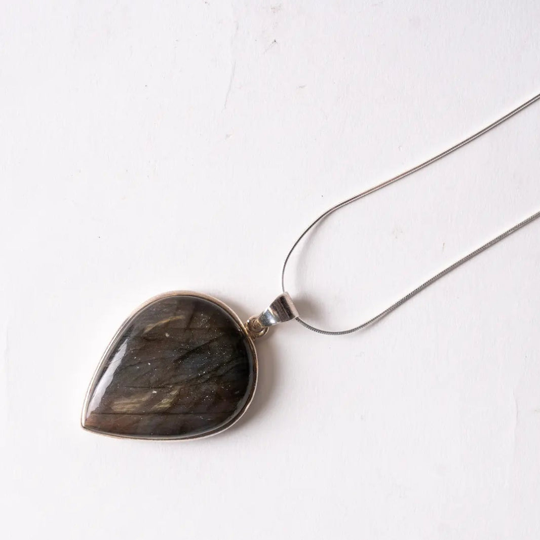 Teardrop-shaped Labradorite pendant Necklace on a white background