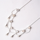 Silver necklace with moonstone beads on a light background