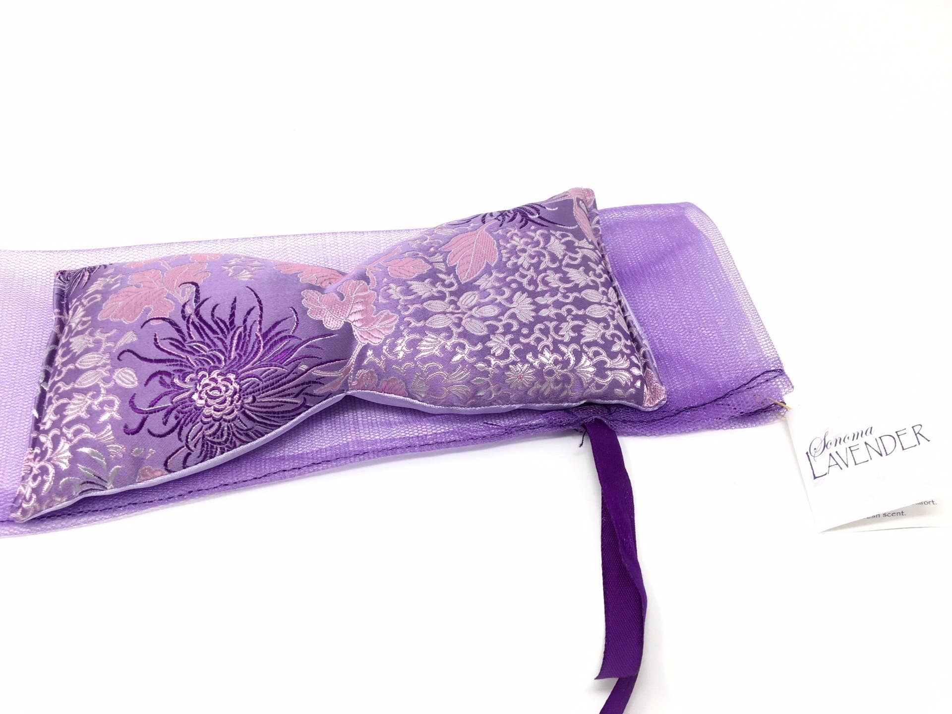 Purple lavender pillow with floral design on a white background