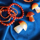 Carnelian Carved Mushroom Sculpture Shown With Carnelian Stretch Bracelets