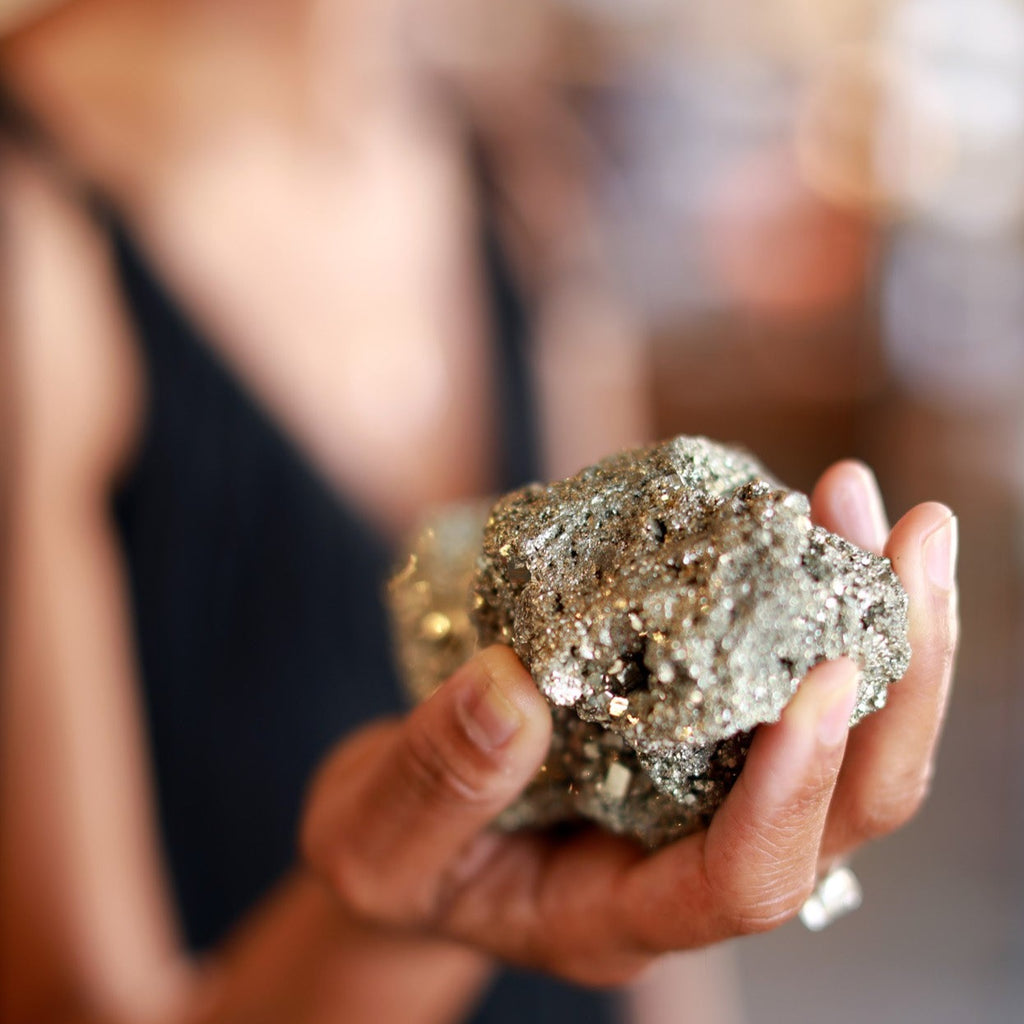 Woman Holding a Cocada Pyrite Cluster in Her Hand