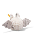 A plush bat keychain or bag charm with fluffy white fur, gray wings, and a small yellow tag, photographed on a clean white background.