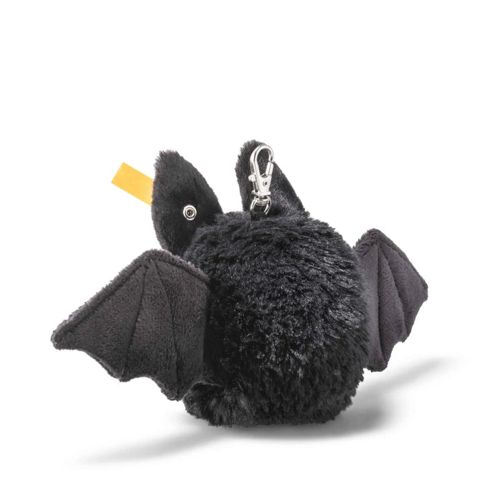 A black plush bat keychain or bag charm with fabric wings and a silver metal clasp, shown on a clean white background.