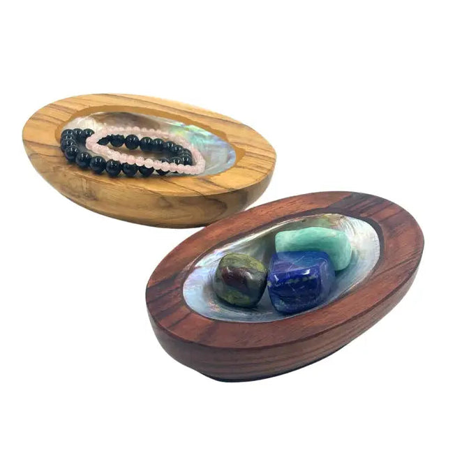 Two wooden bowls with shell inlays on a white background