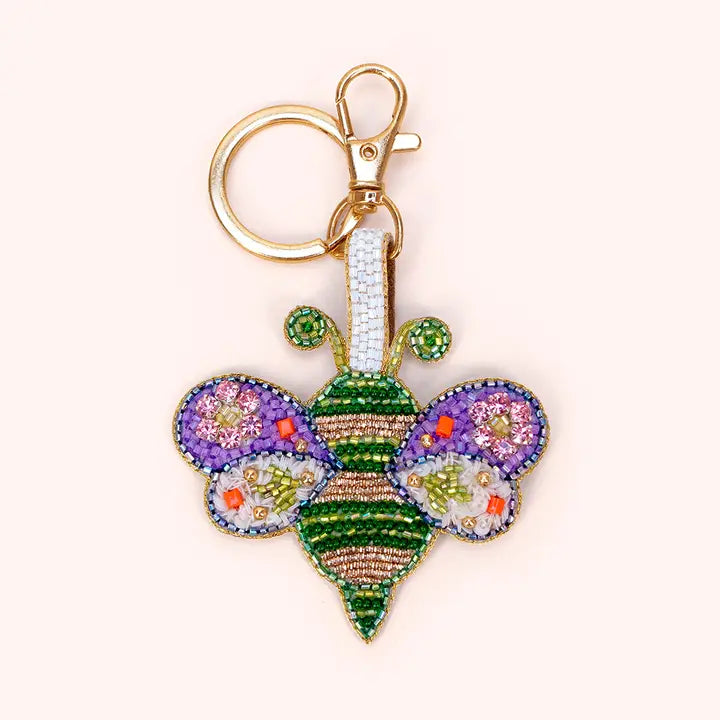 Colorful butterfly-shaped keychain with rhinestones on a white background