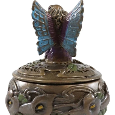 Decorative incense burner with butterfly design on a white background
