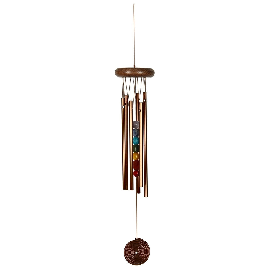 Chakra wind chime with colored beads on a white background