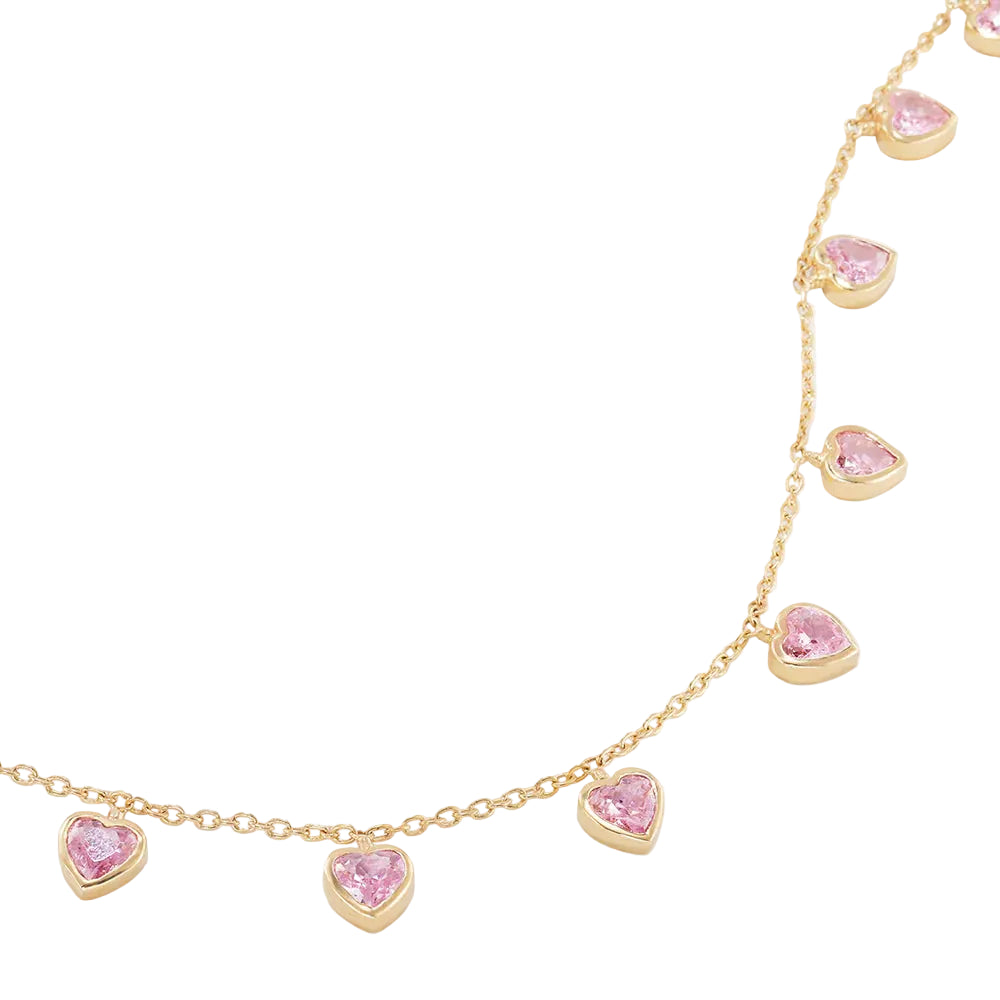 Gold anklet with pink heart-shaped gemstones on a white background
