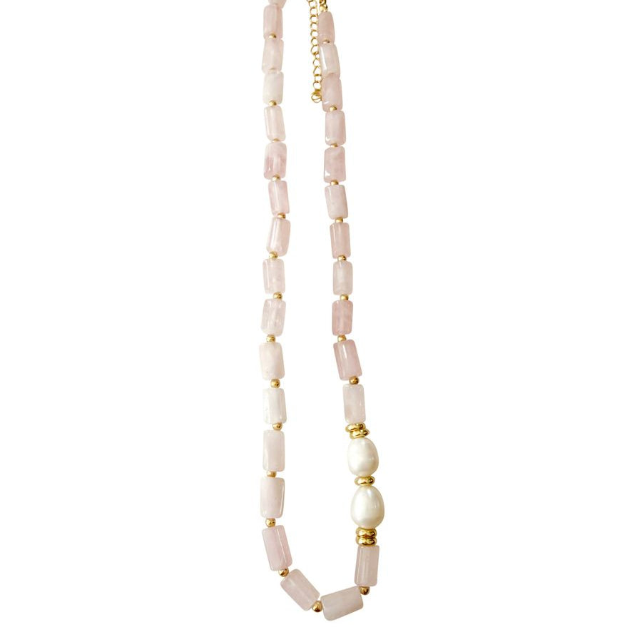 Necklace with pink rose quartz beads and gold accents on a white background