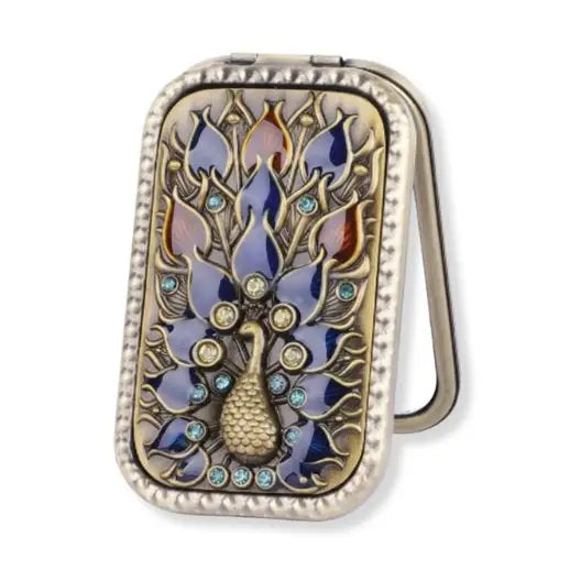 Decorative compact mirror with peacock design on a white background