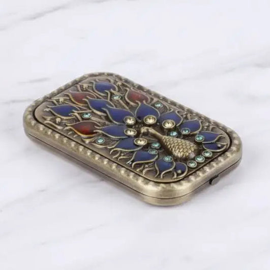 Decorative phone case with peacock design on a white background
