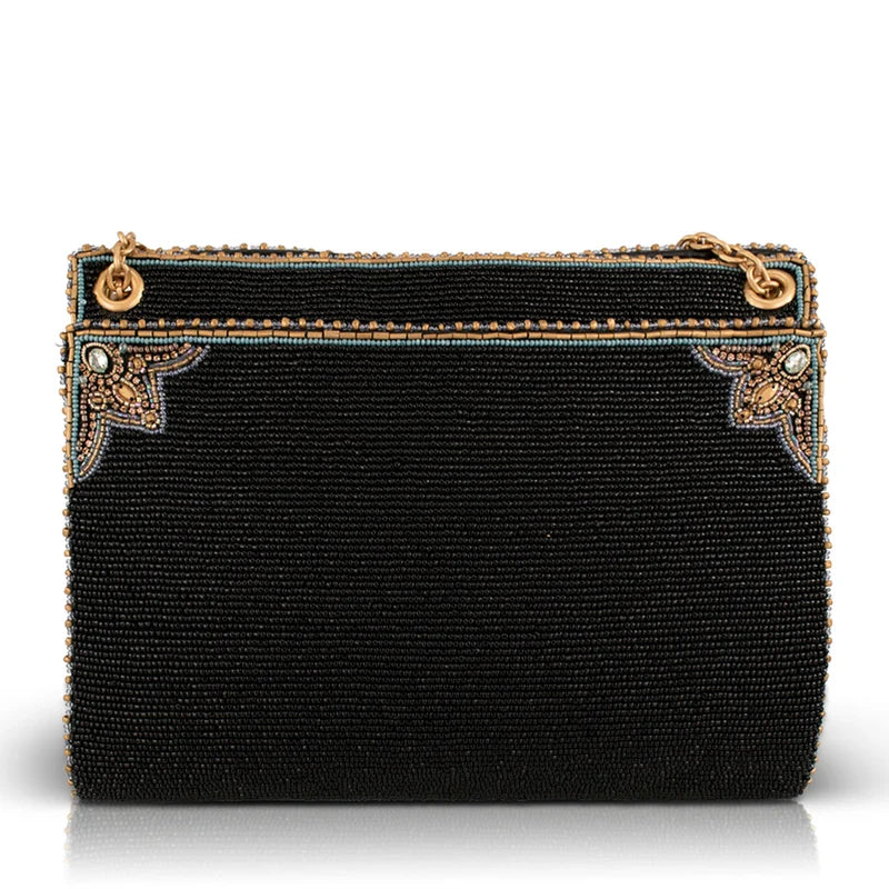 A black beaded clutch purse with gold-tone hardware and decorative corner embellishments, shown against a plain white background.