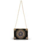 Black handbag with gold chain strap on a white background