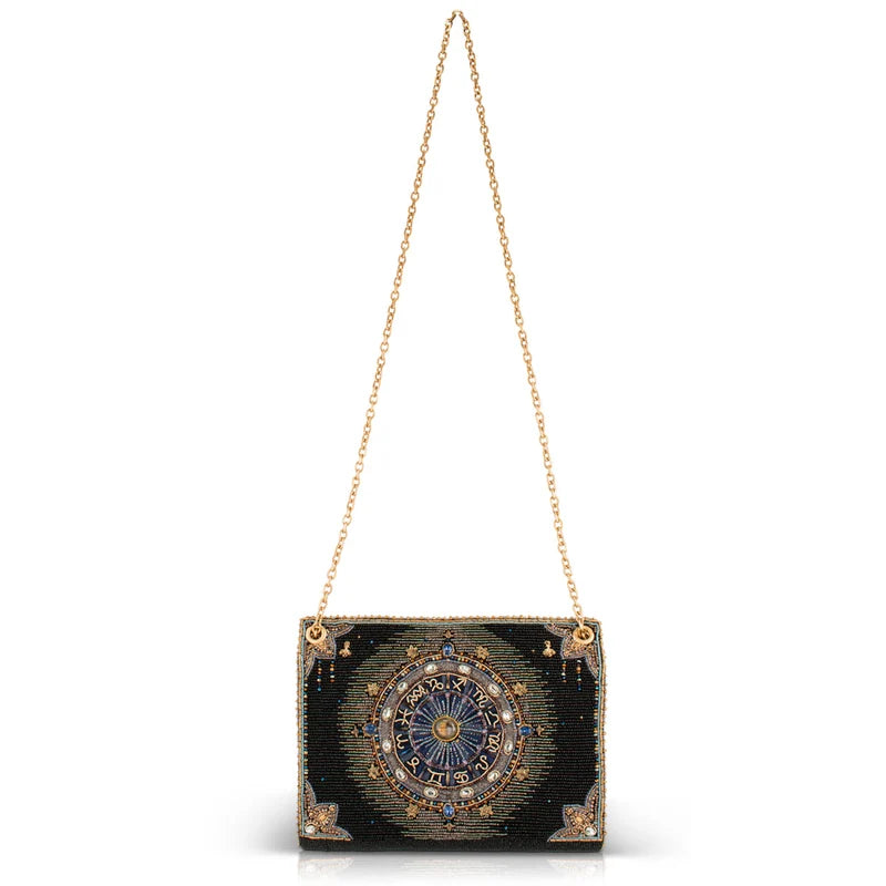 Black handbag with gold chain strap on a white background