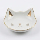 Cat-shaped trinket dish with gold accents on a white background