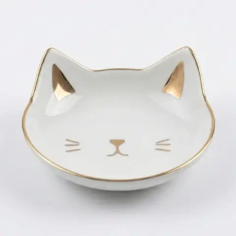 Cat-shaped trinket dish with gold accents on a white background
