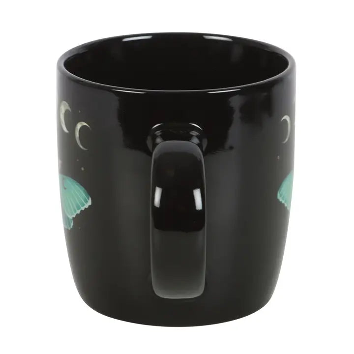 Black mug with designs on a white background