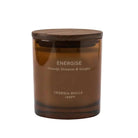An amber glass jar candle with a dark brown wooden lid, featuring white text that reads 'ENERGISE Orange Blossom & Ginger' and 'CEREALIA MOLLA 1899'.