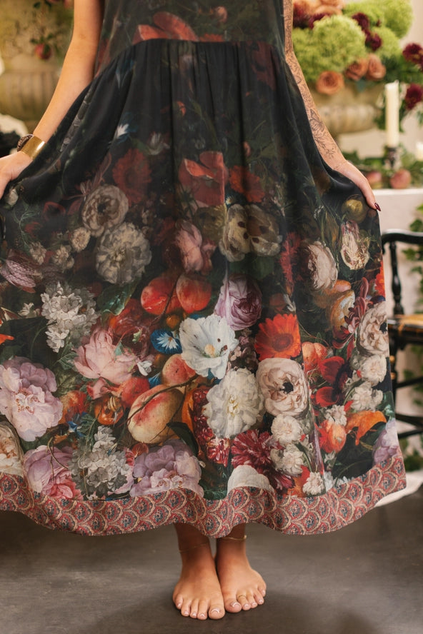 Person wearing a floral and animal print skirt with a blurred indoor background