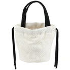 A cream-colored woven bucket bag with black fabric shoulder straps, shown against a plain white background.