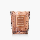 Decorative Gingerbread Chalet candle with embossed design and Voluspa branding on a white background