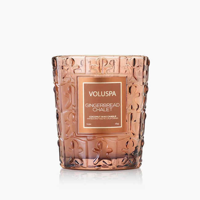 Decorative Gingerbread Chalet candle with embossed design and Voluspa branding on a white background
