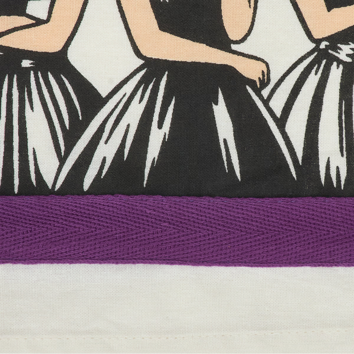 Close-up of a textile product showing a black-and-white graphic print of dancers' lower bodies with a wide purple horizontal stripe across the middle on an off-white fabric background.