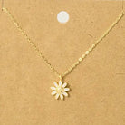 Gold necklace with a flower pendant on a brown card with text
