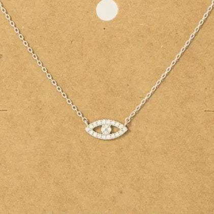 Silver necklace on a brown card with 'Must Have' branding