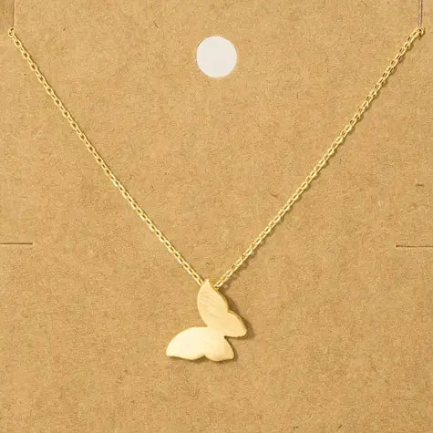 Gold butterfly necklace on a brown card with text