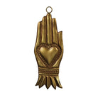 A gold-toned metal wall hanging shaped like a praying hand with a heart motif in the center and a small hanging loop at the top, shown on a plain white background.