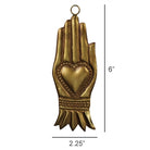 A gold-toned metal ornament shaped like a praying hand with a heart motif in the center, shown with dimension labels indicating 6 inches tall and 2.25 inches wide on a white background.