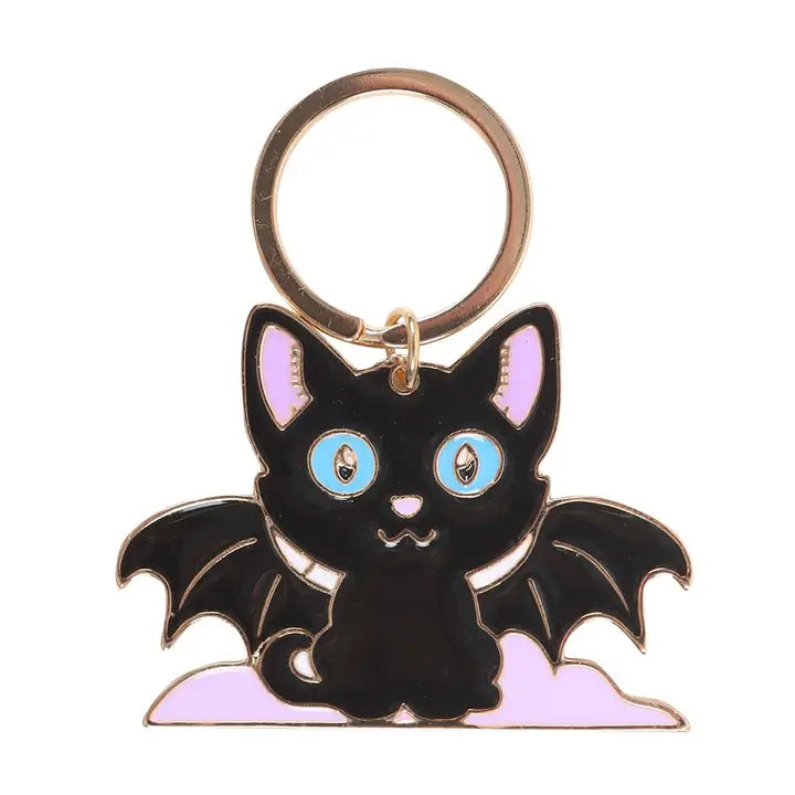 Keychain shaped like a black cat with bat wings on a white background