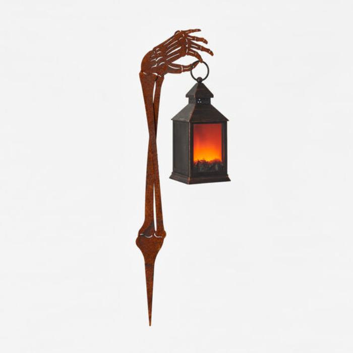 Metal Skeleton Arm Holding a Fire Light Lantern